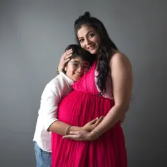 A sweet moment between a mother and her son. He lovingly hugs her and the baby bump, already stepping into his role as a protective big brother.