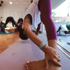 A deep forward fold, Padangusthasana (Big Toe Pose), in our studio. This pose helps to lengthen the hamstrings and calm the mind.