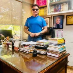 Behind my desk, I am focused on the details of your case. The stacks of books and papers represent the depth of research that goes into every matter I handle, from civil suits to criminal defense.