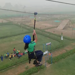 A student experiences the exhilaration of the zip-line, a popular activity at our adventure camp. We ensure the highest safety standards with professional instructors and equipment, allowing children to step out of their comfort zones.