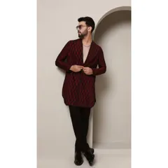 The 'Maroon Ragalia' kurta is designed for a man with a bold sense of style. The deep maroon fabric is textured with a diamond-cut pattern and black pintucks, creating a sophisticated and modern V-neck kurta.