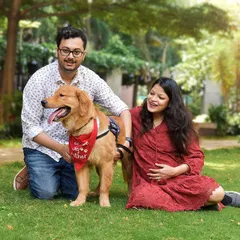 This is the kind of photo that belongs on the wall. A classic family portrait with everyone looking so happy and relaxed, including the furry big brother who is clearly the center of their world.