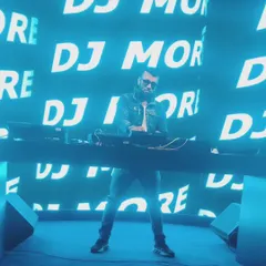 In my element, commanding the stage with my name up in lights. This is the energy and presence I bring to large-scale events, making sure every beat hits with maximum impact.