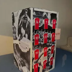 For the football fan, this gift was wrapped in a custom black-and-white collage of Arsenal players, with miniature jerseys representing key team members. It's an example of how I incorporate personal passions into my designs.