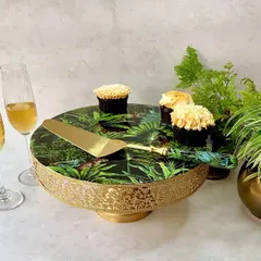 Elevate any celebration with our stunning Amazonia cake stand and server set. The lush, vibrant forest print and luxurious gold finish bring a touch of the tropics to your dessert presentation.