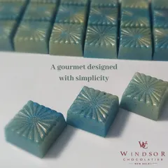 An example of my artistic approach to chocolate making. These gourmet bonbons are colored with cocoa butter to create a beautiful blue shimmer, proving that chocolate can be both delicious and a work of art.
