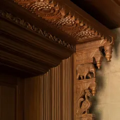 A close-up of the 'karigari' or craftsmanship. This detail of a carved wooden bracket showcases the incredible skill of the artisans and the deep connection to traditional Indian decorative arts.