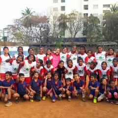We partner with NGOs to empower kids through sports. This photo shows a happy and diverse group of children in their team uniforms, highlighting our commitment to community development.