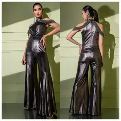 A full view of the metallic gunmetal jumpsuit, showcasing its wide-leg silhouette and the dramatic beaded off-shoulder detail. This is fusion wear at its boldest.