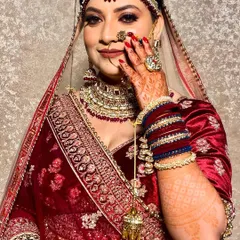 Here is another angle of this beautiful bride, showcasing her complete look. From the flawless makeup and intricate jewelry to the perfectly manicured red nails, every detail came together for her special day.