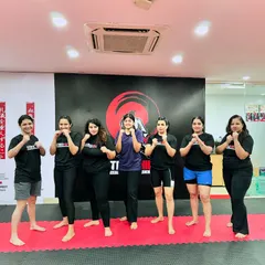 A group of women from our academy stands together in a fighting stance. This image captures the strength, solidarity, and spirit of the female members of the StrikeHive community.