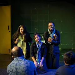 Actors from First Drop Theatre during a Playback Theatre performance, creating an intimate and connected moment with the audience.