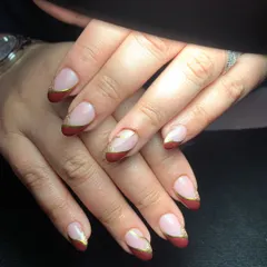 A bold and festive twist on the classic French manicure. This design uses a deep maroon polish for the tips, accented with a fine gold line to add a touch of luxury. It's a great example of how I can customize a classic style to match your personality or a special event.