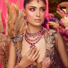 The full look in all its glory. The vibrant makeup is a perfect match for the colorful floral lehenga by Aisha Rao.