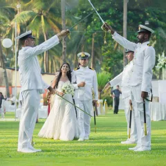 A grand and memorable moment as the couple passes through the traditional Arch of Sabers. This is a highlight of a military wedding that I capture with a sense of honor and celebration.