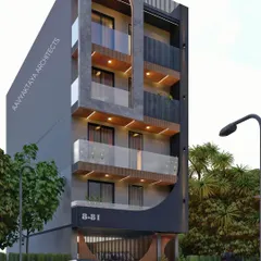 A design for an "Aavyaktaya Home," where the architecture aims for timelessness. The facade features a prominent arch, textured grey concrete, and warm wood accents under the balconies. The curved details at the ground level create an inviting and unique entrance.