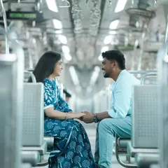 I love the symmetry of the train car in this shot, which frames the couple perfectly. Their interaction feels natural and happy, making this a great candid moment from our Mumbai local train pre-wedding shoot.