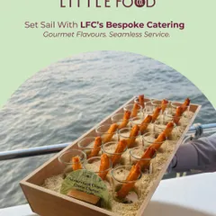 Set sail with our bespoke catering. This image showcases our ability to provide gourmet flavors and seamless service on the water, with appetizers like goat cheese churros served against an ocean backdrop.