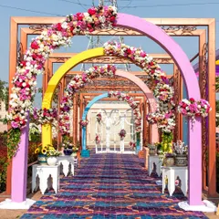 This Haldi entrance features a rainbow of floral arches, creating a spectacular and joyful passageway for guests. My goal is to make every part of the venue a photo opportunity.