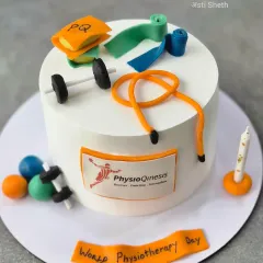 A custom cake for World Physiotherapy Day, decorated with handcrafted, edible physiotherapy equipment like resistance bands and weights.