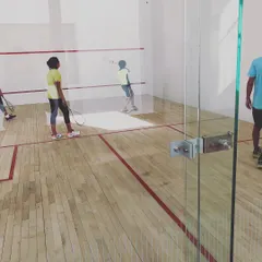 Two young players practice their swing technique inside the court. We ensure every player gets ample court time to work on the core skills of the game.