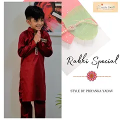 A respectful namaste from a happy client in his custom maroon silk kurta. This image captures the pride and joy a well-fitting traditional outfit can bring to a child during festive moments.