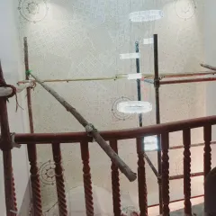 This is a view of a large-scale decorative project in progress. We use scaffolding to safely and precisely apply intricate stencil patterns to high ceilings and walls, ensuring a perfect result even in challenging spaces.