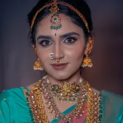 For this look, I layered stunning pieces of temple jewellery to create a regal effect. The makeup is kept classic with defined eyes and a neutral lip to balance the grandeur of the accessories.