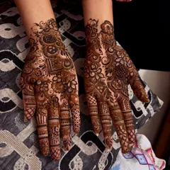 A dense and intricate non bridal design that covers the entire back of the hand. The mix of patterns creates a rich and textured look.