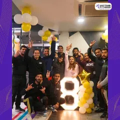 Celebrating 8 amazing years. Our team and members pose with a giant "8," marking our anniversary. We're grateful to everyone who has been a part of our journey.