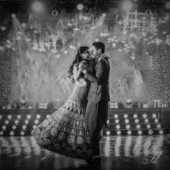 A timeless black and white shot of the couple's first dance, capturing the romance and elegance of the moment under a ceiling of hanging butterflies.