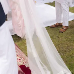 A detail shot of the bride's long, elegant veil as she walks during her Nikaah ceremony. This photo highlights the beauty and grace of traditional bridal attire.