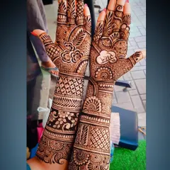 A close-up showing the name 'Ram' written in Hindi script inside a heart, a popular way to personalize bridal mehandi.