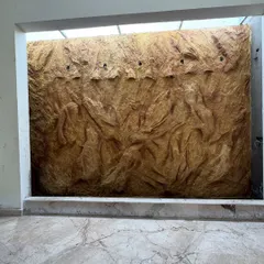 The fountain wall mural after painting and finishing, but before the final installation of lights and water. The golden-brown tones give it a natural, earthy feel, ready to be brought to life.