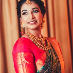 A beautiful portrait of a South Indian bride in her traditional silk saree and temple jewelry, looking elegant and serene.