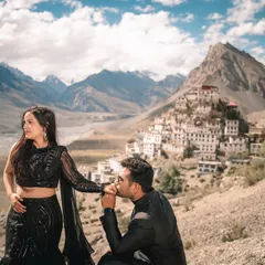 A tender kiss on the hand, a classic romantic gesture made epic by the awe-inspiring backdrop of Key Monastery and the Spiti mountain range.