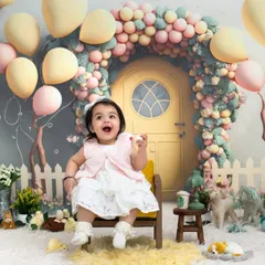 A fairytale entrance for a little princess turning one. This elaborate setup with a whimsical balloon arch and a storybook door highlights the imaginative and high-quality sets we design for milestone birthdays.