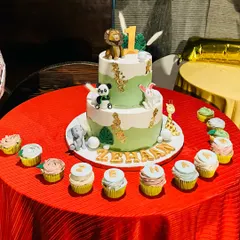 The final setup of the two-tier jungle animal cake for Gauahar Khan's son's first birthday, complete with matching cupcakes spelling out his name.
