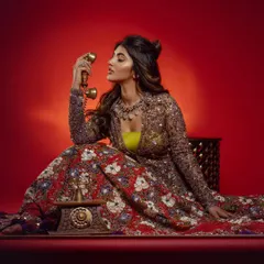Another shot of Sreeleela from the same series, using a vintage telephone as a prop. This adds a touch of retro charm to the heavily embellished traditional outfit, creating a unique narrative for the photo.
