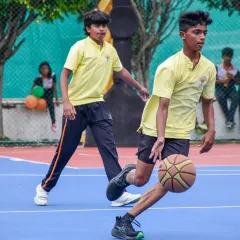A young player dribbles the ball down the court during our Interschool Basketball Tournament, showcasing his speed and control.