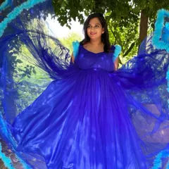 This royal blue maternity gown with a dramatic ruffled trail is designed to make a statement. It creates a beautiful circular frame for stunning overhead shots.