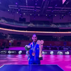 Divyanshi, beaming with pride, holding her trophy and medals after her historic win at the Asian Youth Championship in Tashkent. A testament to her hard work and our academy's high-performance training.