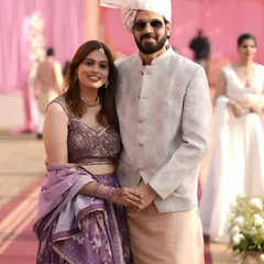 A closer look at this happy couple. You can see how the tones of his outfit pick up the colors in her beautiful floral lehenga, making them look perfectly put-together.