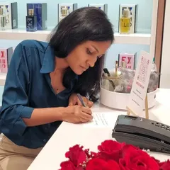 Deep in focus writing a custom message for a customer. Live calligraphy allows guests to see the art unfold, making their personalized gift feel even more special.