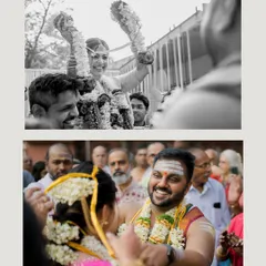 The varmala or garland exchange ceremony, captured in a dynamic black and white shot that focuses on the couple's happy expressions.