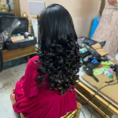 Bouncy, defined curls for a party look. This open hairstyle is glamorous and fun, perfect for adding volume and movement.