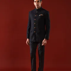 The quintessential Bandhgala, presented in a deep, textured black. This ensemble is the epitome of sharp, modern royalty, featuring a flawless bespoke fit and ornate buttons that provide a touch of classic distinction for any formal occasion.