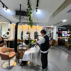 A stylist at work on a client's hair. This image captures the everyday focus and precision that goes into every haircut and style at my salon.