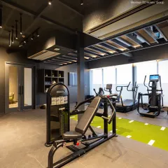 My cardio section includes treadmills and elliptical trainers, situated next to a turf track for functional training. The large windows provide natural light to energize your workout.