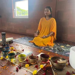 A beautiful, intimate sound healing and breathwork session. The room is decorated with flowers, and the air is filled with intention as participants settle in for a journey of deep relaxation.